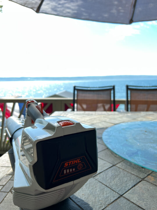 STIHL Leaf blower sitting on patio table over looking lake