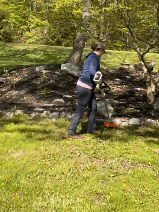 using SITHL trimmer to trim around garden