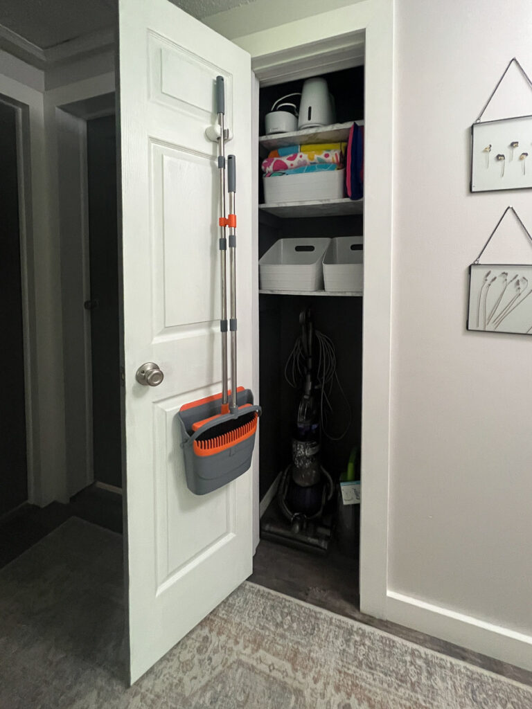 linen closet with door open and blue paint