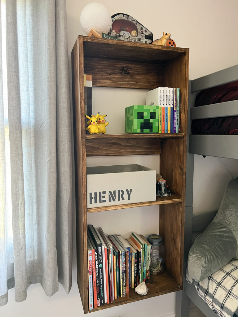 Hanging nightstand next to a bunk bed