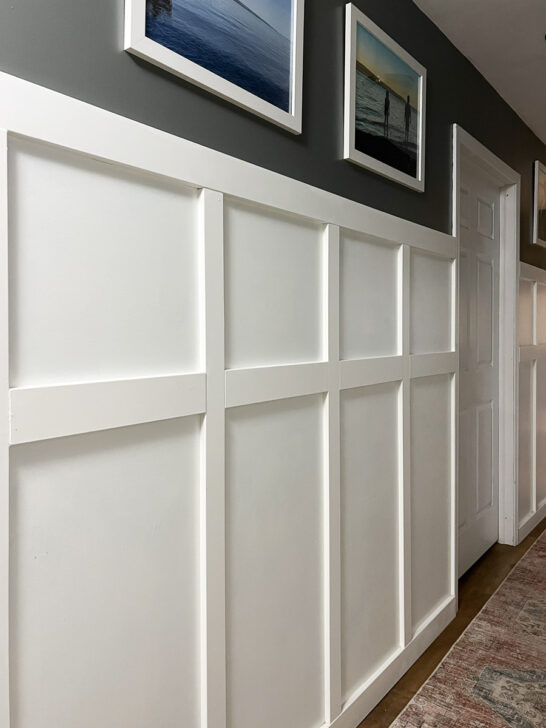 white board and batten in a hallway with dark gray painted wall on top