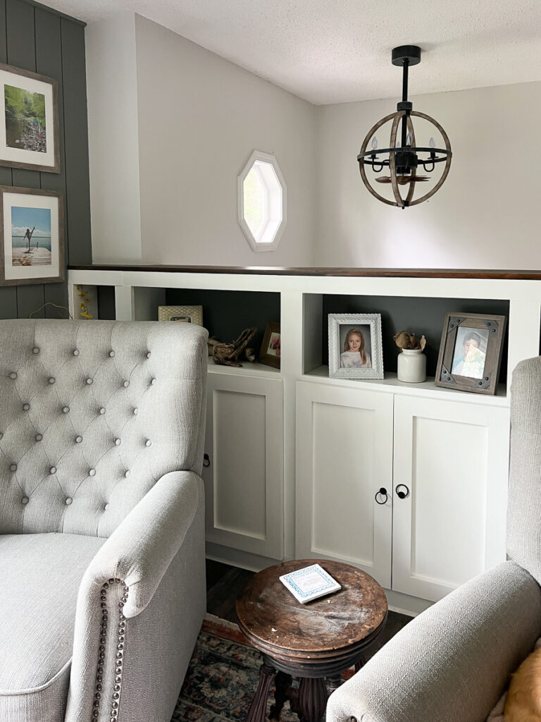 raised ranch entry way with a fandelier and two recliners